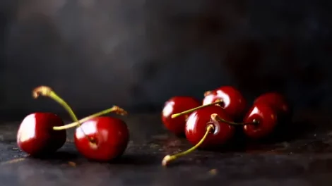 Cherries on a dark gray surface.