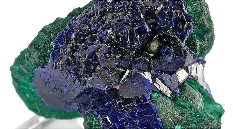 An electric blue specimen of Azurite overlaying chatoyant malachite. | Azurite Meaning and Uses