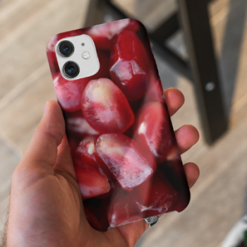 A man holding an iPhone 11 with our Pomegranate Seeds iPhone case.