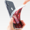 Peeling our Pomegranate Seeds iPhone soft case off of an iPhone XS.
