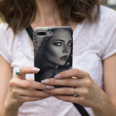 Woman holding iPhone 8 Plus featuring Witch in the City case design.
