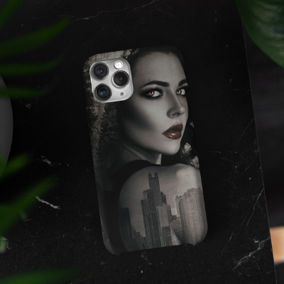 An iPhone 11 case designed with a bewitching woman, sitting on a table surrounded by plants.