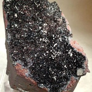 A specular hematite specimen, with large shimmering clusters.