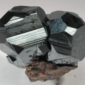 A pair of high lustrous hematite crystals on a matrix.