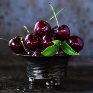 Moistened, deep-red cherries in a silver bowl. • Black Cherry Spiritual Meaning
