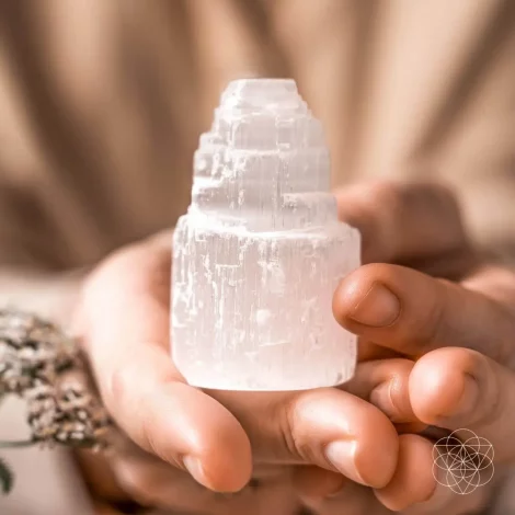 A person holding the Selenite All Cleansing Crystal Tower Clusters from Conscious Items.