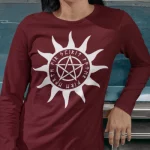 A maroon long sleeve tee with a pentacle graphic encircled by sun rays and elder futhark runes.