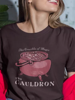 A woman wearing an Oxblood Black Cauldron T-Shirt from Elune Blue on Etsy.
