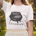 A woman wearing a White Cauldron Tee from Elune Blue on Etsy.