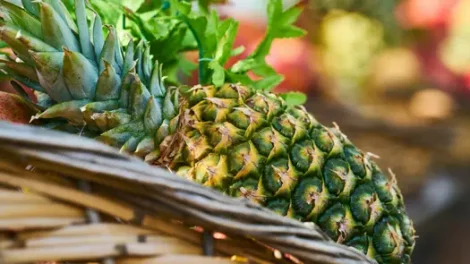 A close-up of a pineapple in a basket.