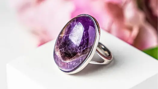 An amethyst stone in a silver ring setting from Conscious Items.