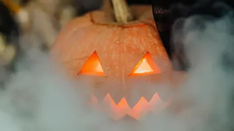 A jack o' lantern shrouded in smoke.