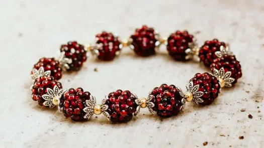 A garnet healing bracelet with garnet clusters that resemble pomegranate seeds from Conscious Items.