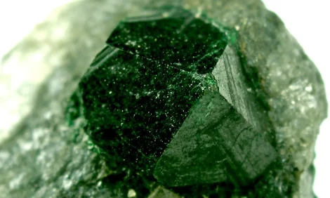 Close-up of a deep green uvarovite garnet crystal.