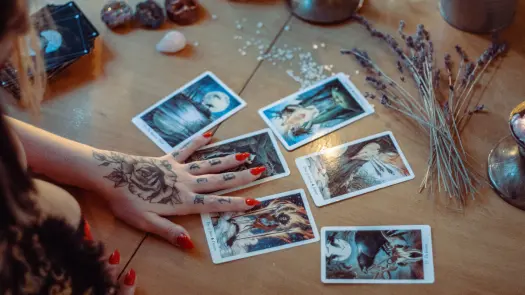 A table with assorted tarot cards spread out on it.