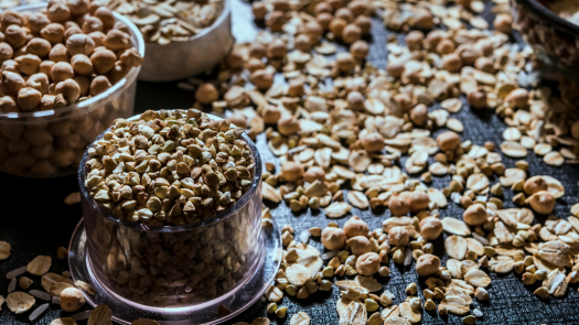 A variety of seeds arranged on bowls, symbolizing the diversity and abundance of life celebrated during Imbolc.